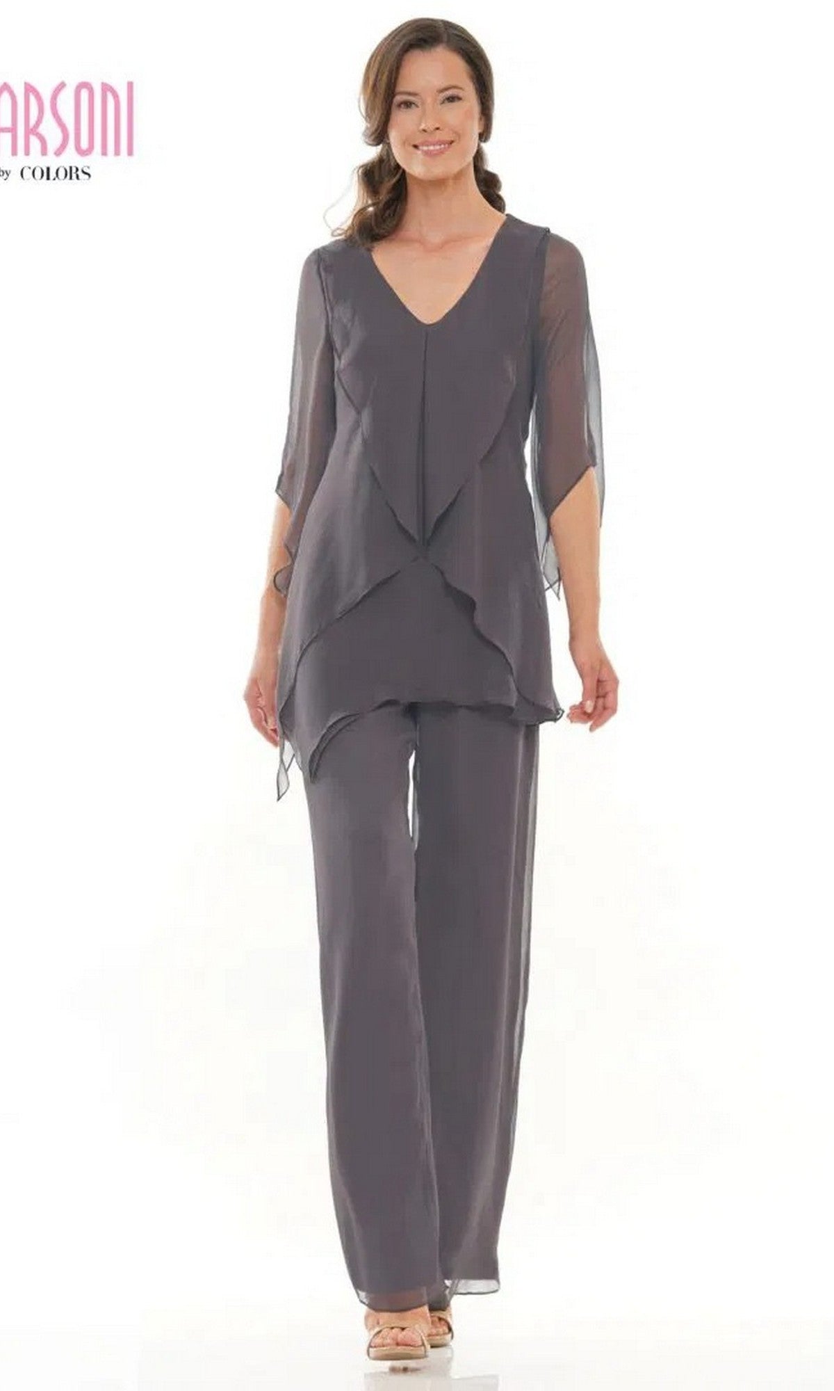 A woman wears the Long Formal Pantsuit: Marsoni M308 in charcoal, featuring a loose fit, layered design with a chiffon blouse and matching wide-leg pants, paired with beige heels against a plain white background.